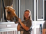 Teen petting horse